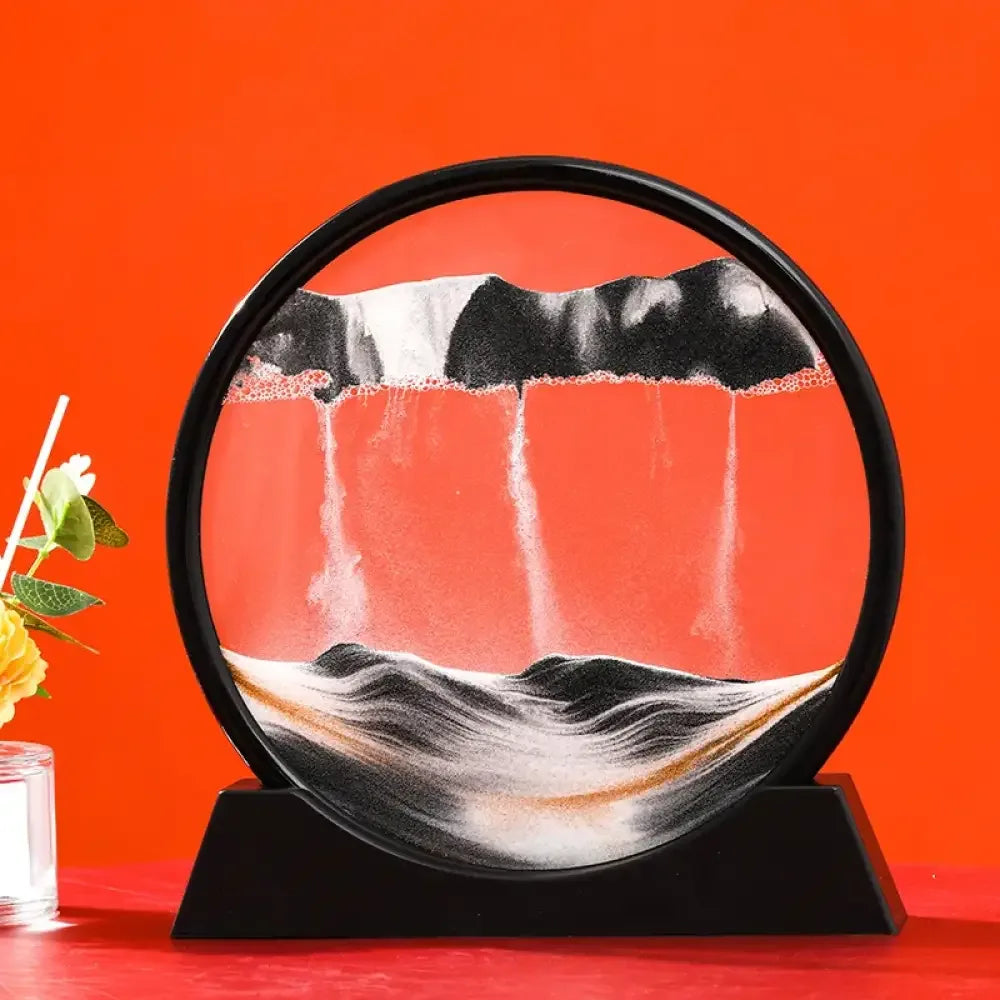 Black circular 3D moving sand art lamp with white and orange sands