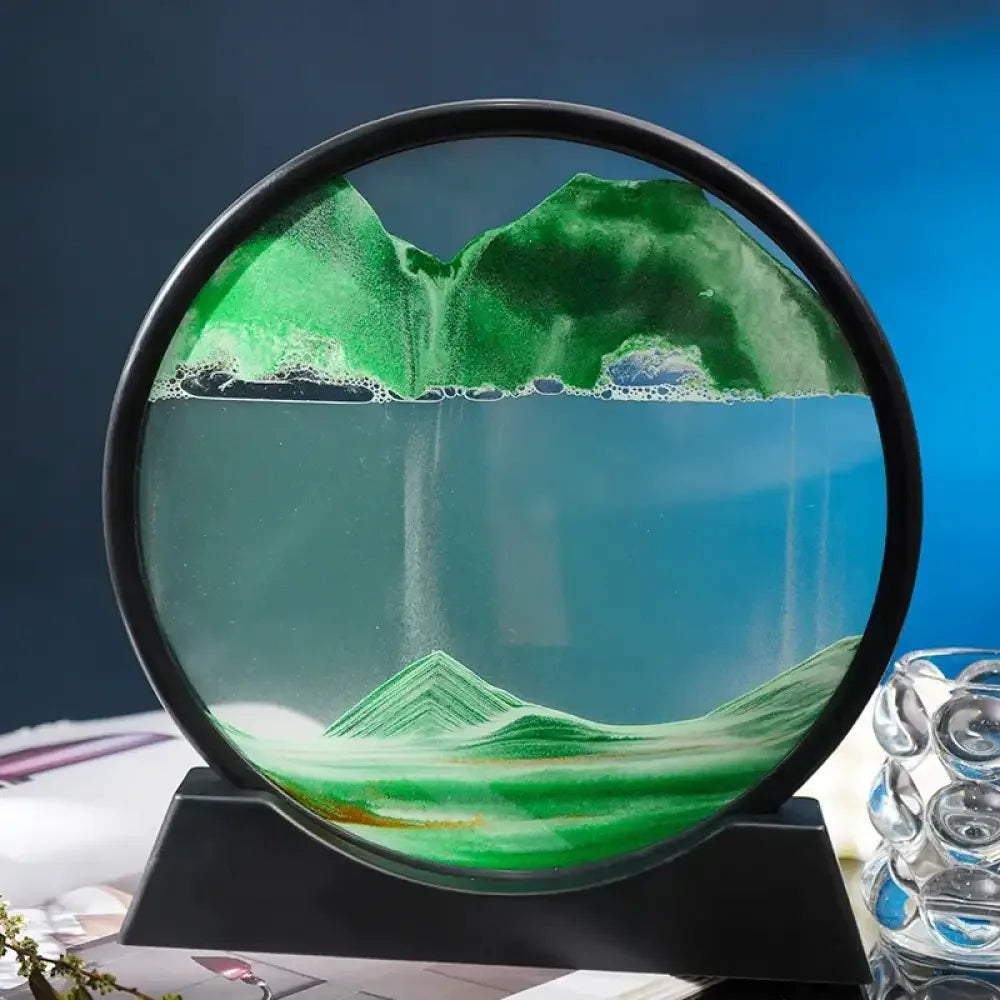 Green and blue glass sphere with moving sand art on black base