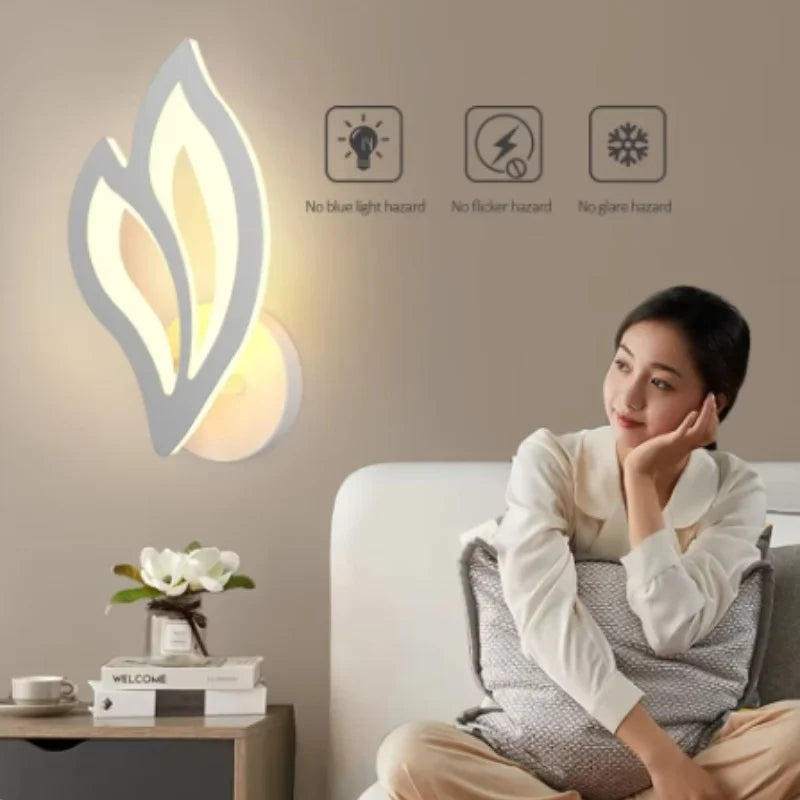 Woman sitting on a couch next to a wall light fixture with safety feature icons.