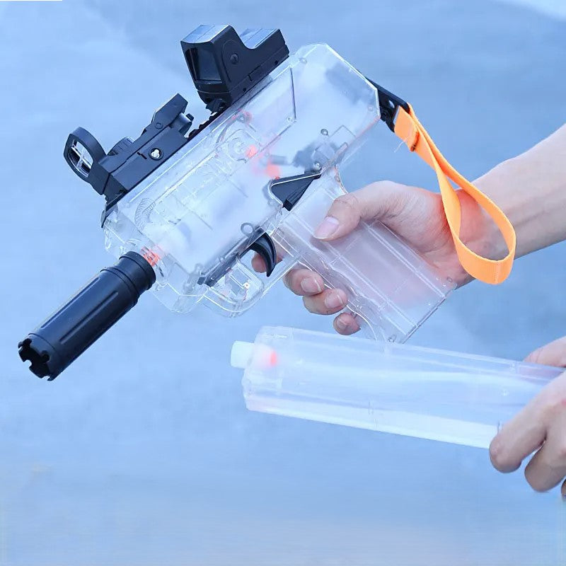 Clear water gun with black and orange accents held by a person against a light blue background