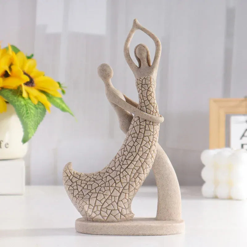 Decorative sculpture of a person in a yoga pose on a white surface with a blurred background