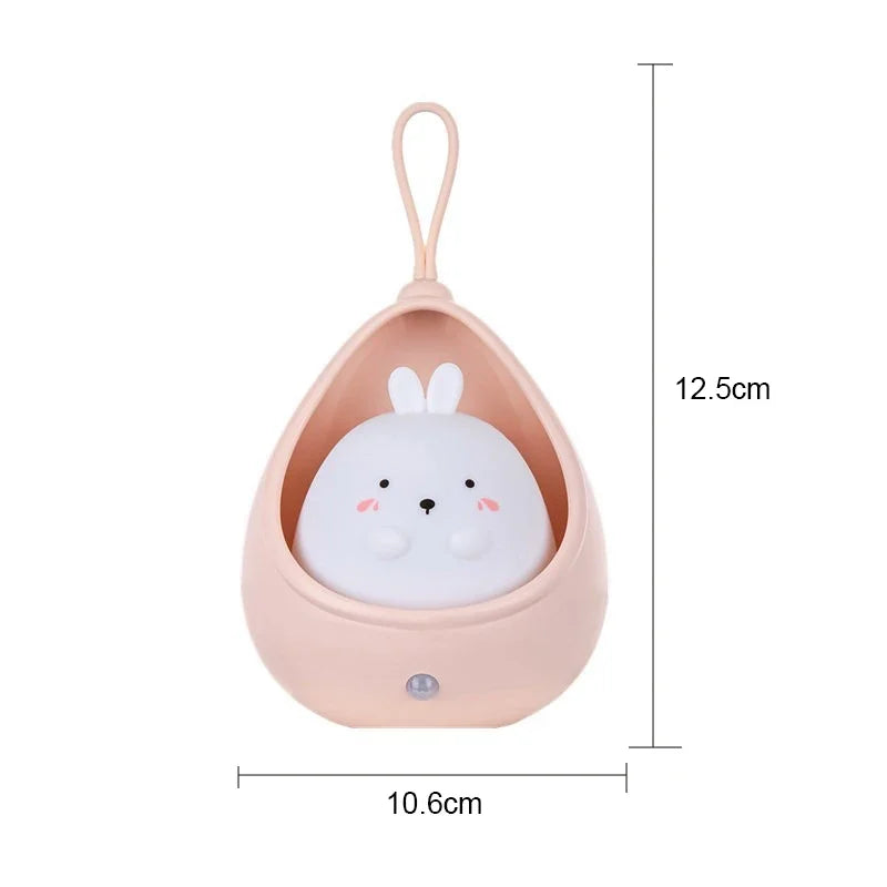 Small plush toy with a pink holder and dimensions indicated on a white background