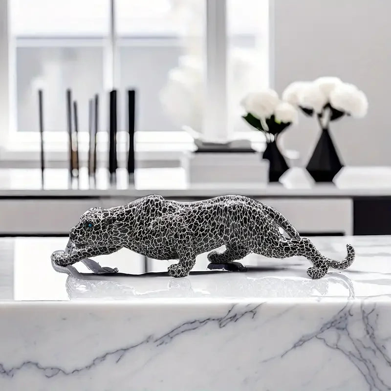 Decorative leopard sculpture on a marble surface with a modern interior background