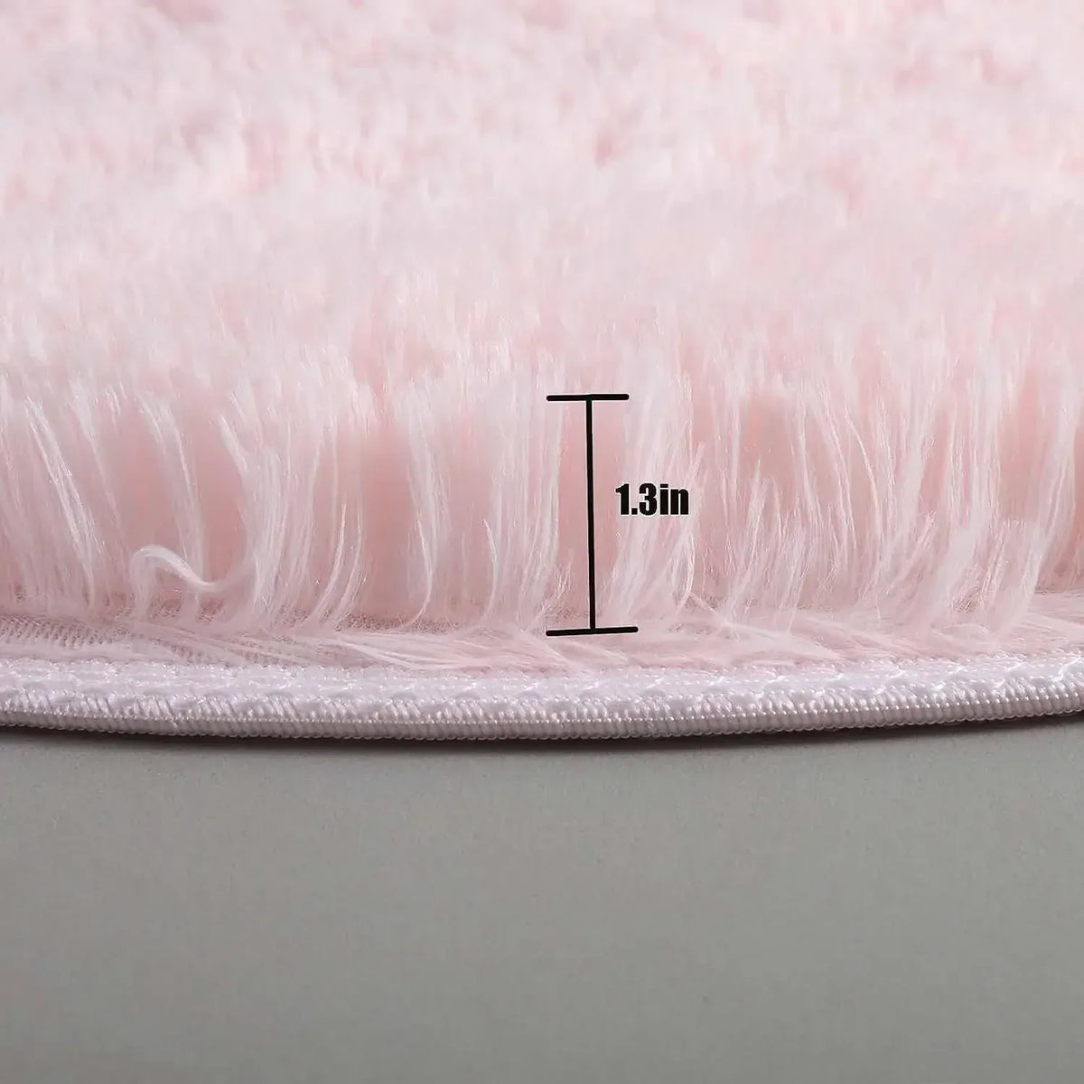 Close-up of pink fluffy material with a measurement label indicating 1.3 inches.