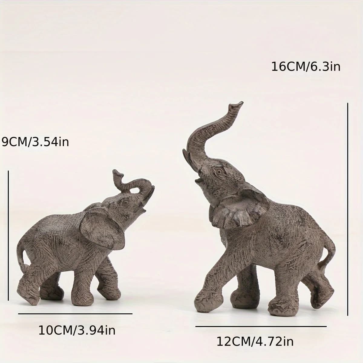 Two elephant figurines with measurements on a white background