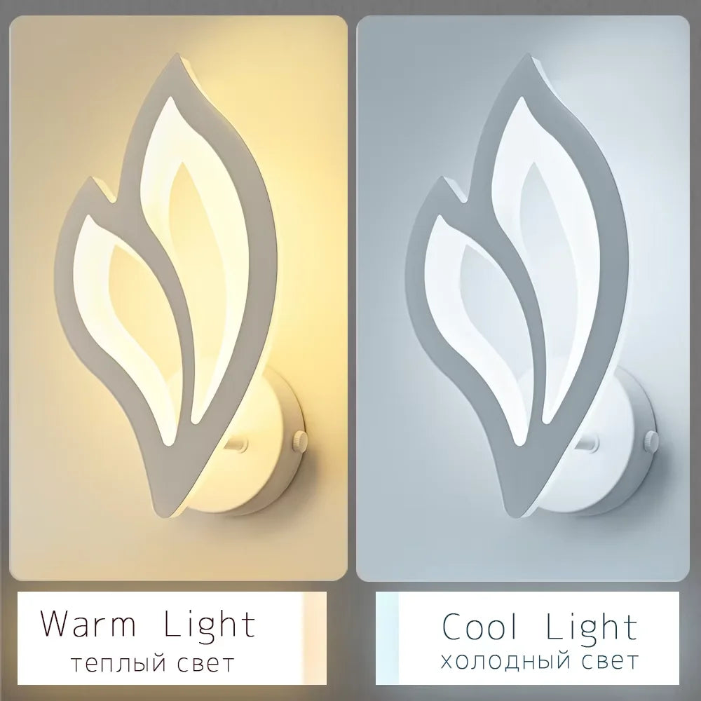 Two wall lights with leaf design, one emitting warm light and the other cool light, on a beige and gray background.