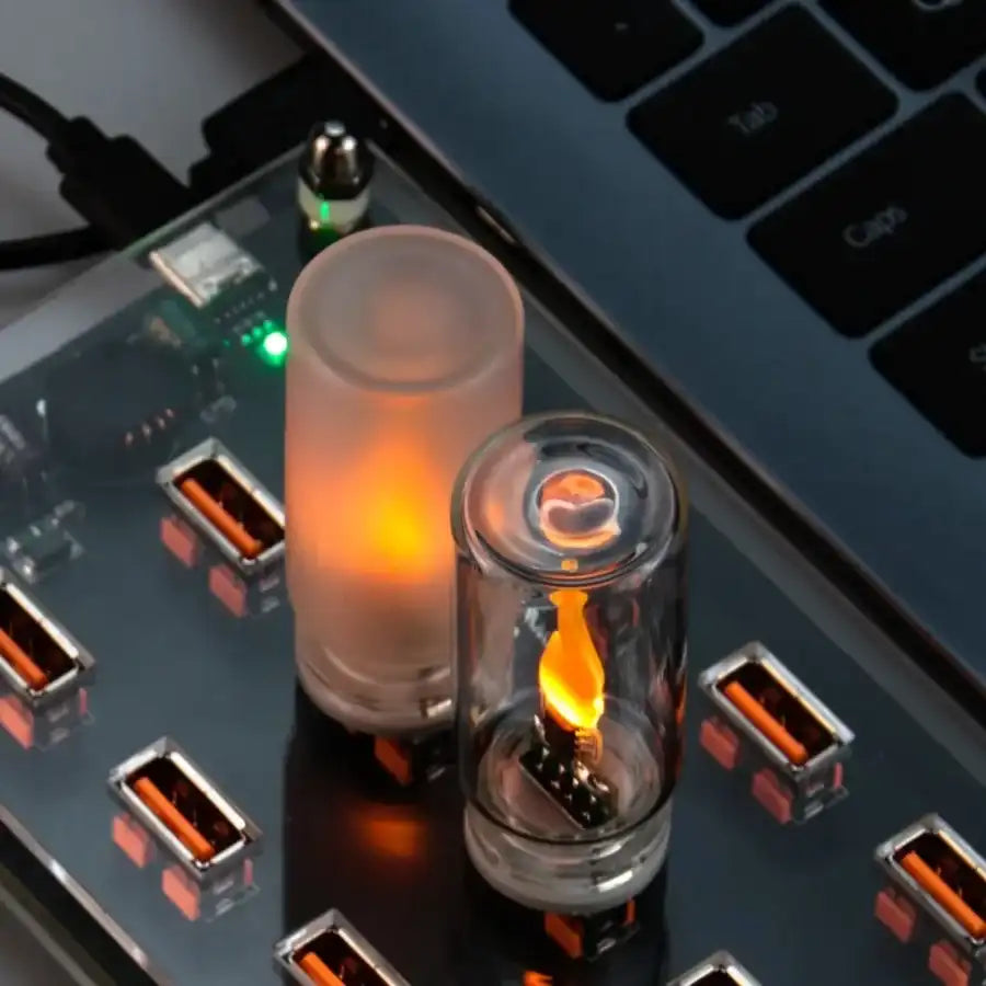 Two glowing cylindrical devices on a laptop with USB ports.