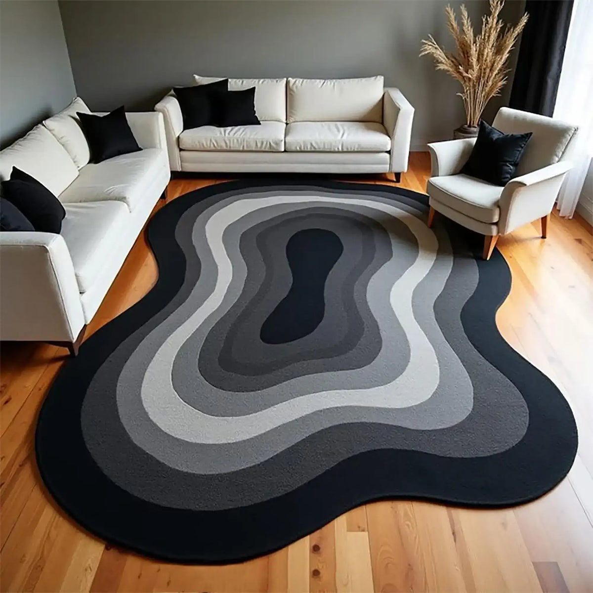 Living room with a modern black and gray area rug, white sofa, and armchair.