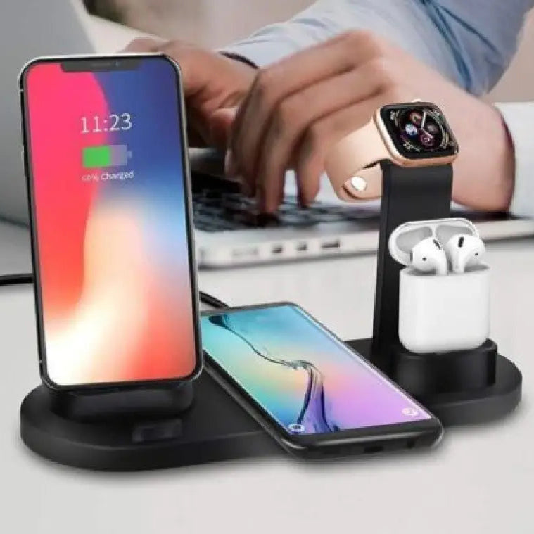 Wireless charging station with smartphone, smartwatch, and earbuds on a desk.
