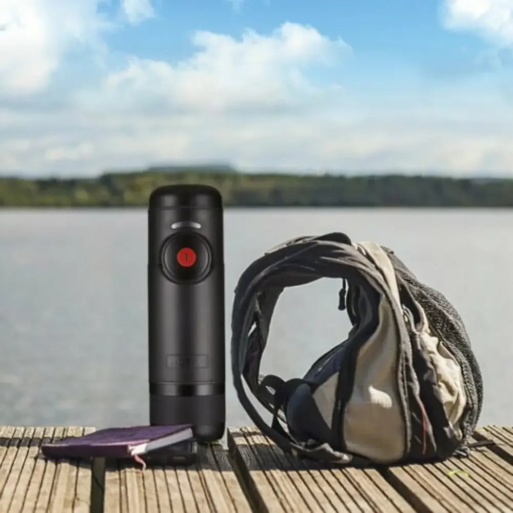 Portable espresso machine with GoPro Hero 9 on wooden dock