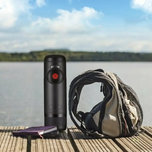 Portable espresso machine with GoPro Hero 9 on wooden dock