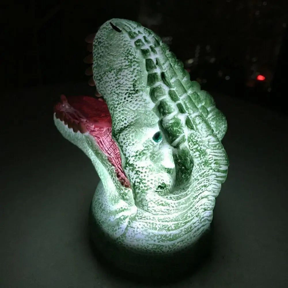 Colorful T-Rex light with green alligator figurine, red mouth and eyes