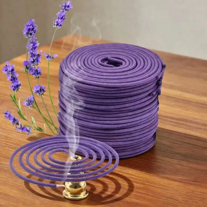 Purple incense coils with a smoking coil on a wooden surface, accompanied by lavender flowers.