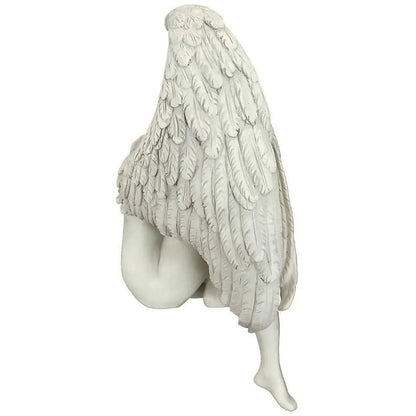 White angel statue with spread wings on a white background