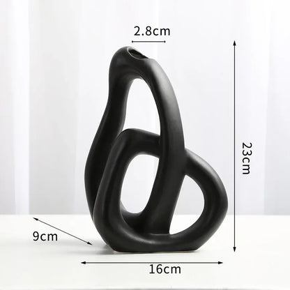 Black abstract sculpture with measurements on a white background