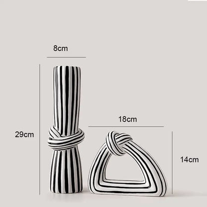 Black and white striped decorative items with measurements on a light gray background