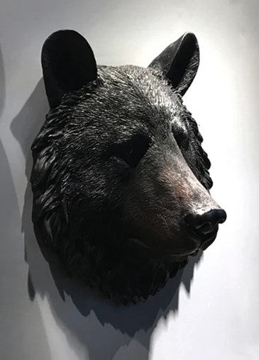 Black bear head mount on a white wall