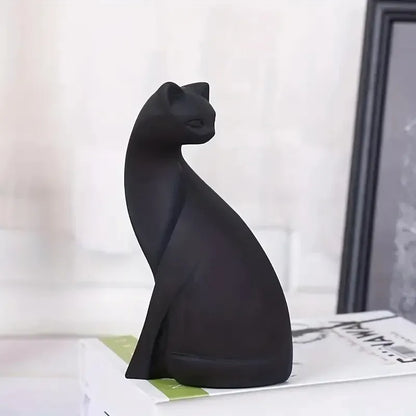 Black cat-shaped decorative item on a surface with a blurred background
