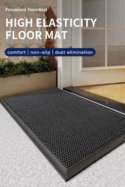 Black doormat with text highlighting features on a light gray floor.