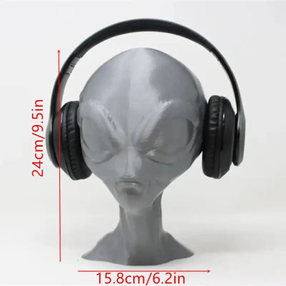 Black headphones on a gray alien head with measurements indicated