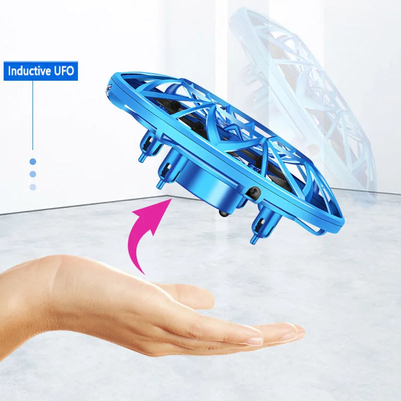 Blue inductive UFO levitating above a hand on a white background