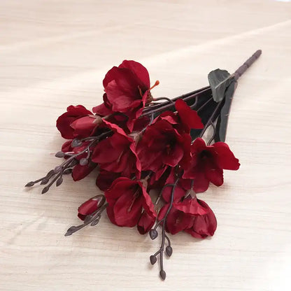 Bouquet of red flowers on a textured beige surface