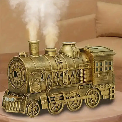 Bronze-colored model of a steam locomotive on a wooden surface with a soft background.