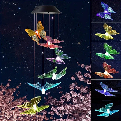 Butterfly-shaped solar light hanging against a dark sky with cherry blossoms.