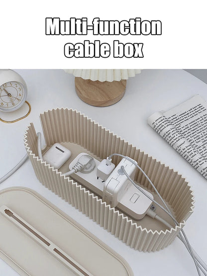 Multi-function cable box organizing electronic devices on a desk.