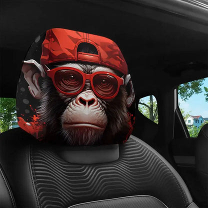 Car headrest cover with monkey design wearing a red cap and sunglasses in a car interior.
