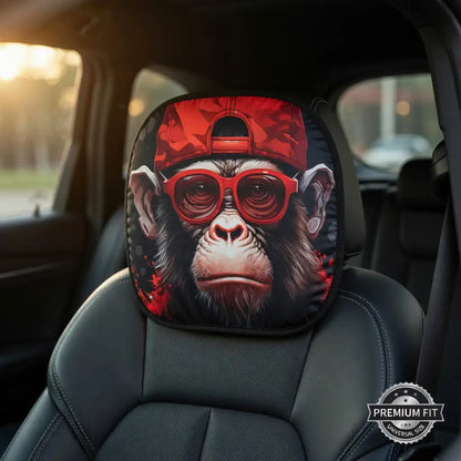Car headrest cover with monkey design wearing a red cap and sunglasses in a vehicle.