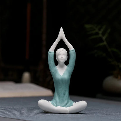 Ceramic figurine of a woman in a yoga pose on a dark background