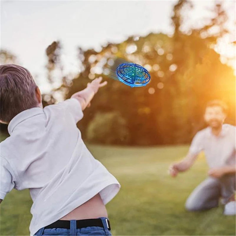 Child playing with a glowing disc in a park with a blurred background
