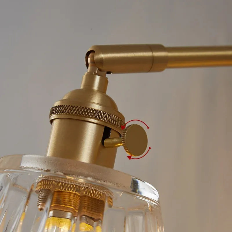 Close-up of a gold ceiling light fixture with a clear glass shade.