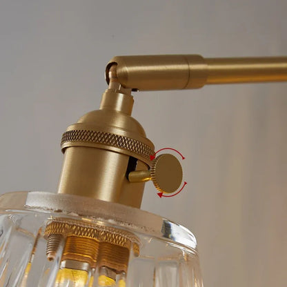 Close-up of a gold ceiling light fixture with a clear glass shade.