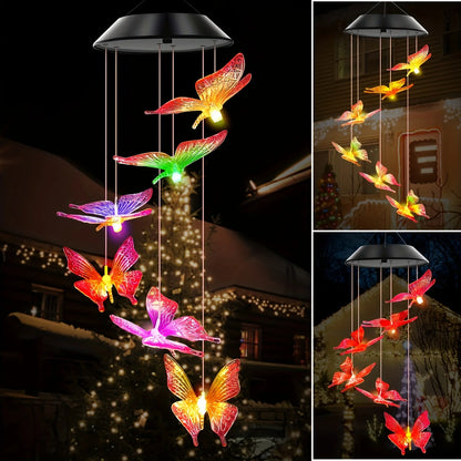 Colorful butterfly-shaped solar lights hanging outdoors at night.