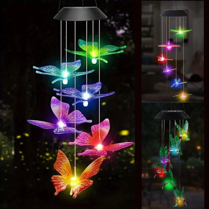 Colorful butterfly-shaped solar wind chime with lights on a dark background