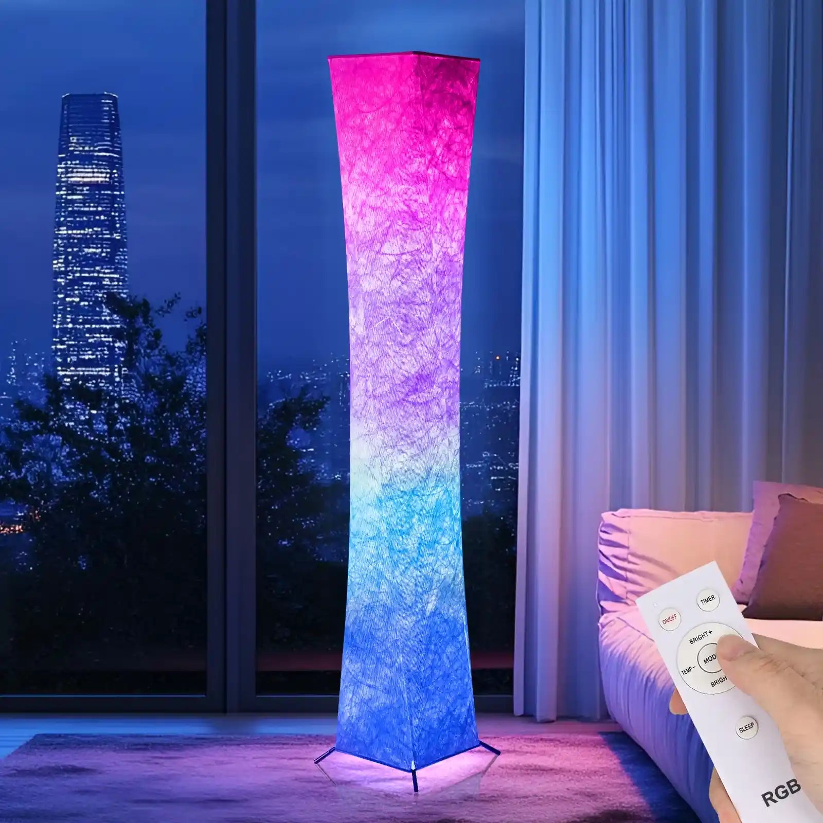 Colorful floor lamp with a remote control in a room with a cityscape view