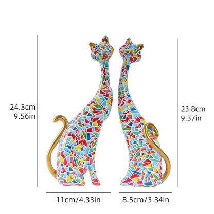 Colorful mosaic cat figurines with measurements on a white background