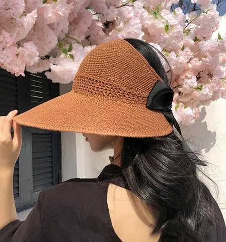Women's beach sun hat showing wide brim UV protection and adjustable velcro closure detail