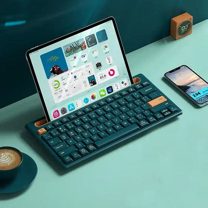 Tablet with a keyboard attached to a desk with a smartphone and a coffee cup.