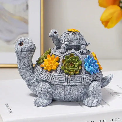 Decorative turtle figurine with flowers on a white surface