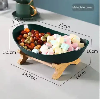 Decorative bowl with wooden stand containing colorful items, shown with measurements.