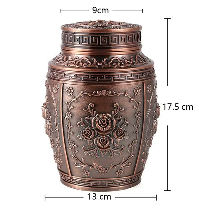 Decorative bronze urn with embossed designs and measurements on a white background