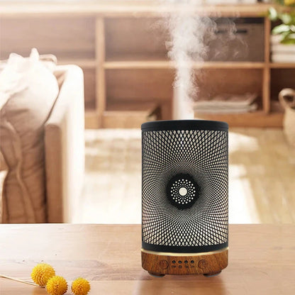 Decorative diffuser emitting steam on a wooden surface with a blurred background