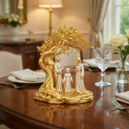 Decorative figurine of a family under a tree on a table with a dining setting in the background.