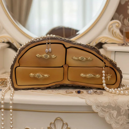 Decorative jewelry box with jewelry on a lace surface in front of a mirror.