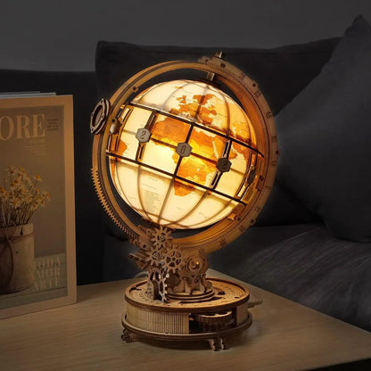 Decorative lamp with gears on a table next to a magazine
