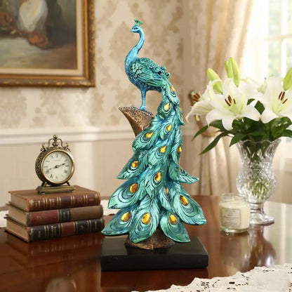 Decorative peacock statue on a table with books and flowers in the background