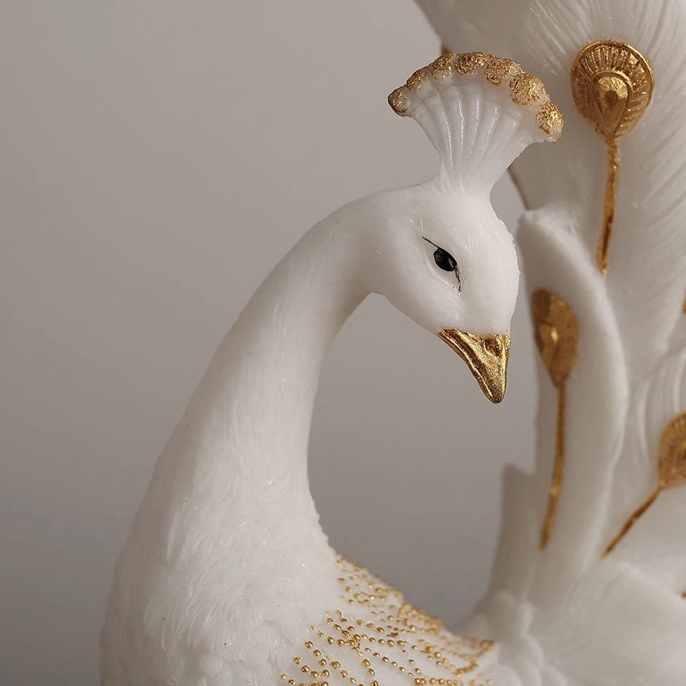 Decorative white goose figurine with gold accents on a plain background